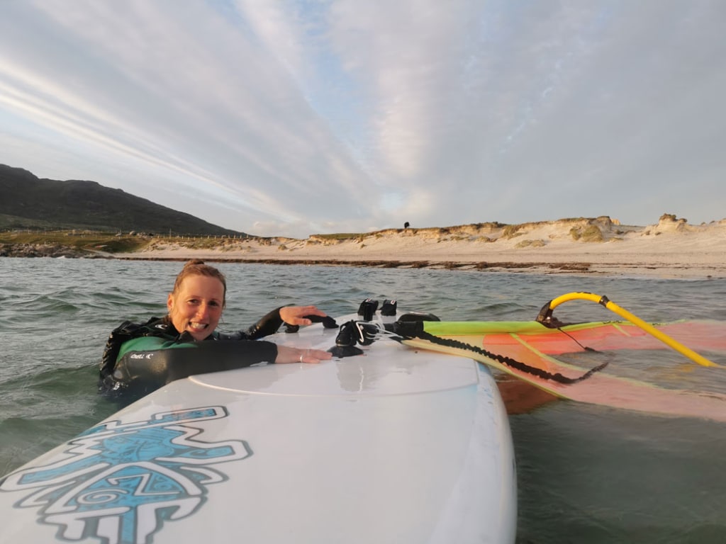 woman at the sea windsurfing