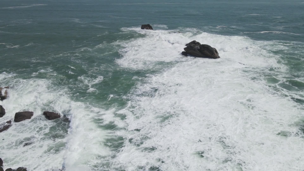 Aerial view of Atlantic waves breaking over a rocky coastline